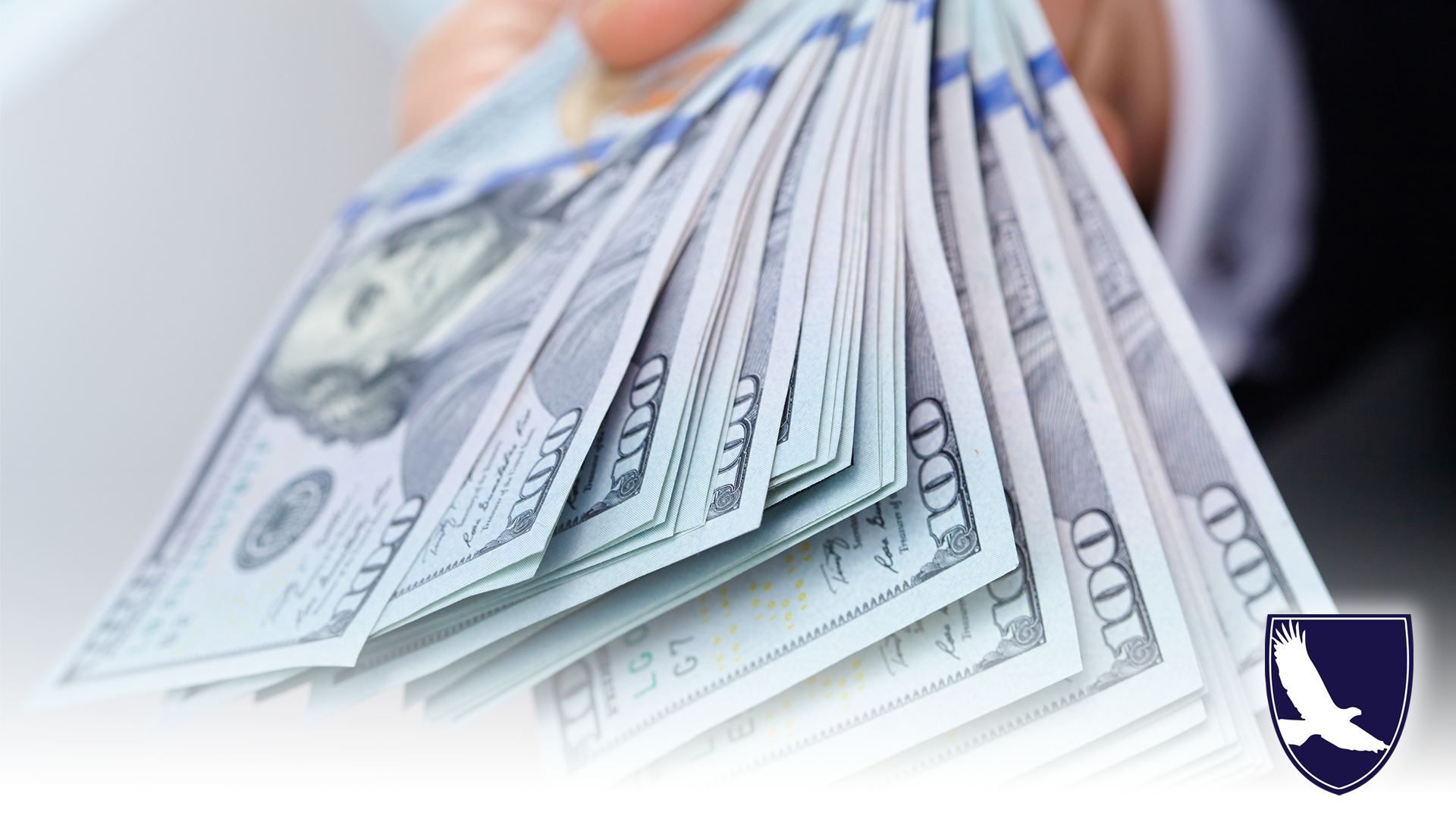 handful of hundred dollar bills